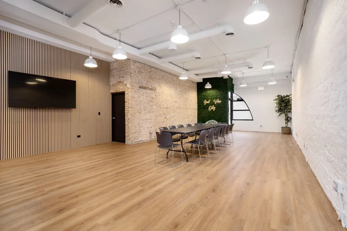 Banquet table setup in the main room, with the TV on the wood slat wall