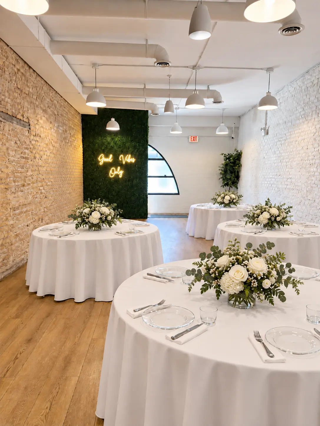 Round tables set with white linens and white flower centerpieces at Montrose Studio in Portage Park