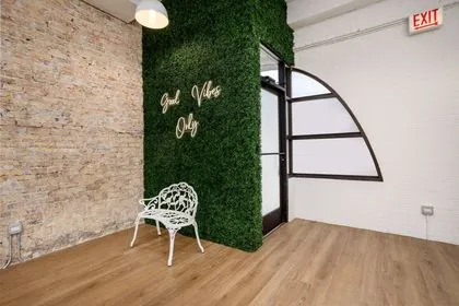 Neon sign photo wall at Montrose Studio in Portage Park